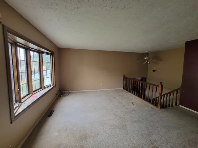 a kitchen with stainless steel appliances a sink dishwasher a refrigerator with white cabinets and wooden floor