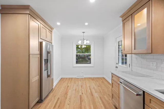 a view of empty room with wooden floor and windows