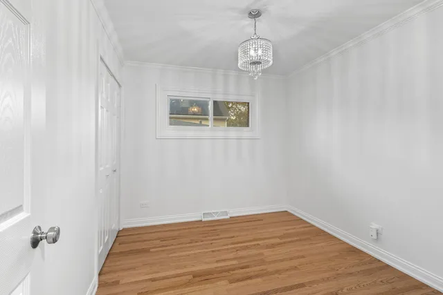 a view of a room with wooden floor and white walls