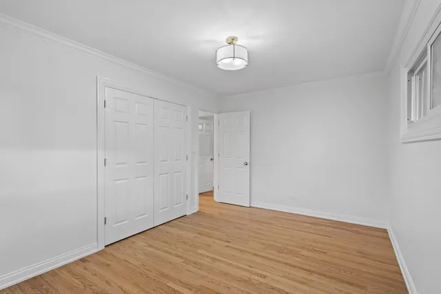 a view of a room with wooden floor and white walls