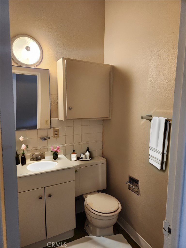 207 East Orchard Street, Unit C Santa Maria, CA 93454 - Photo 10 of 10 a bathroom with a toilet sink and mirror