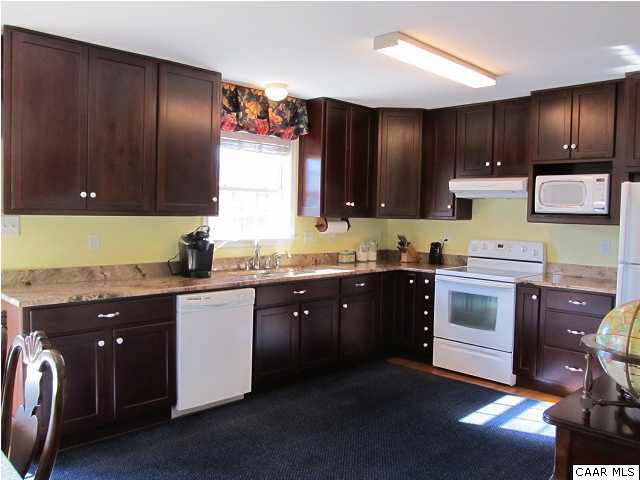 448 Rockfish Run Road Scottsville, VA 24590 - Photo 12 of 27 a kitchen with stainless steel appliances granite countertop wooden cabinets a stove top oven a sink and dishwasher