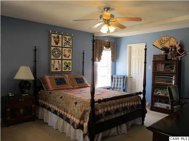 448 Rockfish Run Road Scottsville, VA 24590 - Photo 13 of 27 a bedroom with a bed and a chandelier