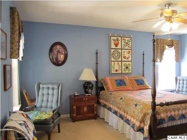 448 Rockfish Run Road Scottsville, VA 24590 - Photo 14 of 27 a bedroom with bed and a chandelier