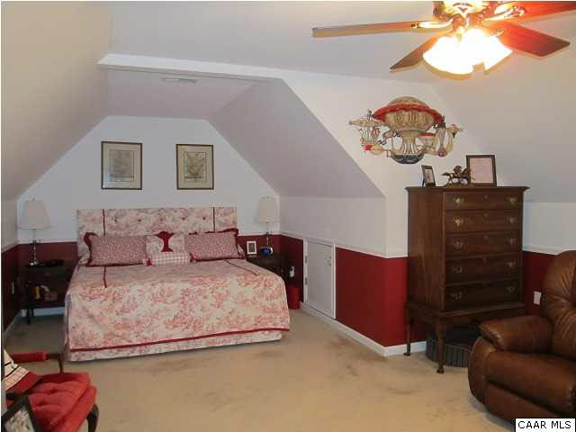 448 Rockfish Run Road Scottsville, VA 24590 - Photo 18 of 27 a bedroom with a bed and a chandelier