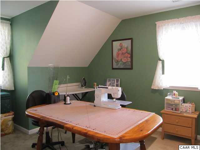 448 Rockfish Run Road Scottsville, VA 24590 - Photo 19 of 27 a room with a table chairs and a wooden floor