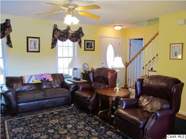448 Rockfish Run Road Scottsville, VA 24590 - Photo 7 of 27 a living room with furniture and a chandelier