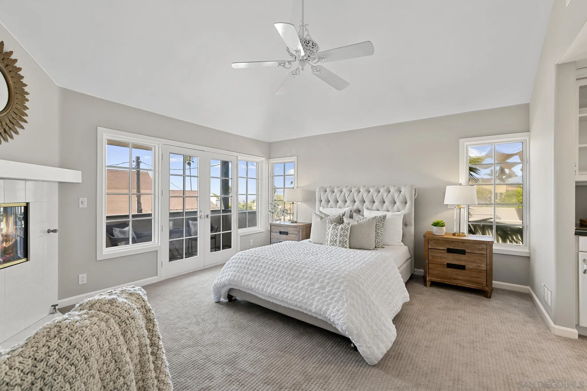 7231 Draper Avenue La Jolla, CA 92037 - Photo 13 of 26 a spacious bedroom with a bed a couch and a large window with the outer view