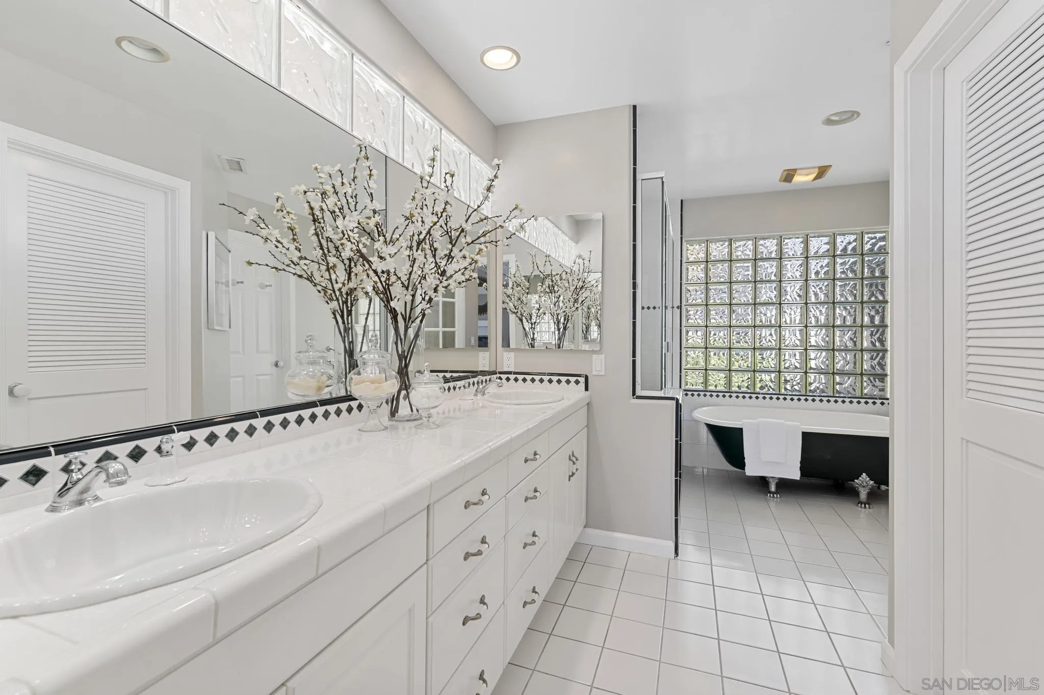 7231 Draper Avenue La Jolla, CA 92037 - Photo 17 of 26 a bathroom with a sink and a mirror