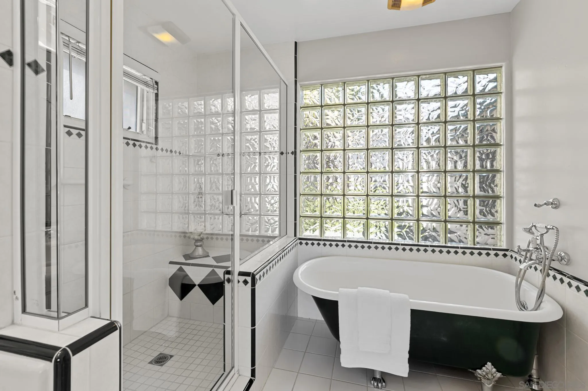 7231 Draper Avenue La Jolla, CA 92037 - Photo 18 of 26 a bathroom with a bathtub and a shower