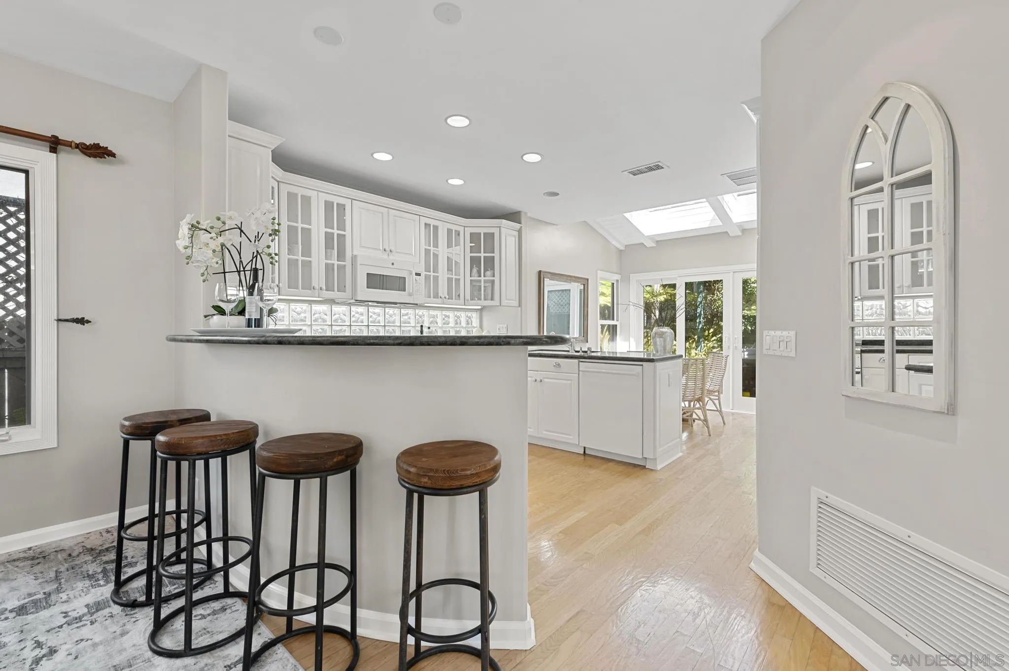 7231 Draper Avenue La Jolla, CA 92037 - Photo 7 of 26 a kitchen with stainless steel appliances granite countertop a dining table chairs and view living room