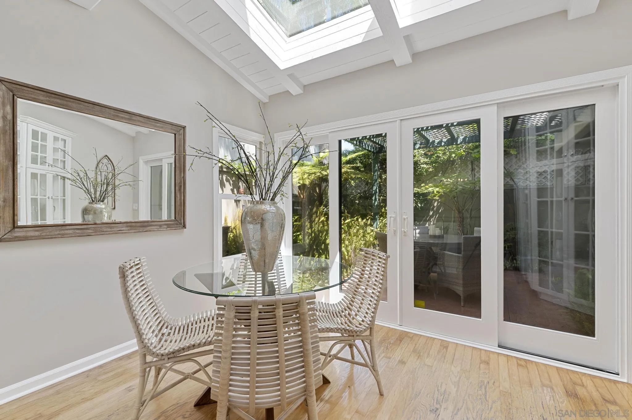 7231 Draper Avenue La Jolla, CA 92037 - Photo 10 of 26 a dining room with furniture and large windows
