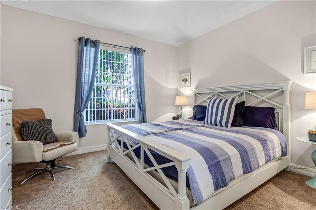 8416 Benelli Court Naples, FL 34114 - Photo 11 of 12 a bedroom with a bed chair and window