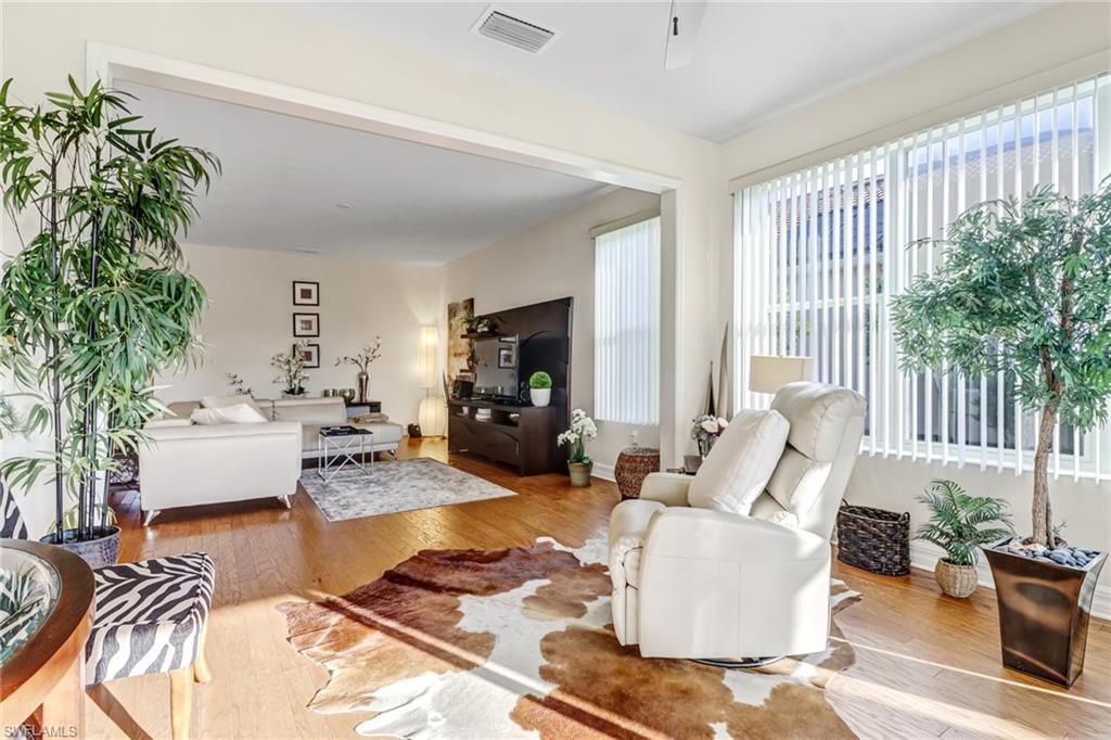 8416 Benelli Court Naples, FL 34114 - Photo 7 of 12 a living room with furniture and a potted plant