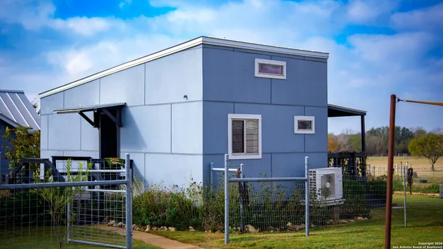 a view of a brick house with a yard