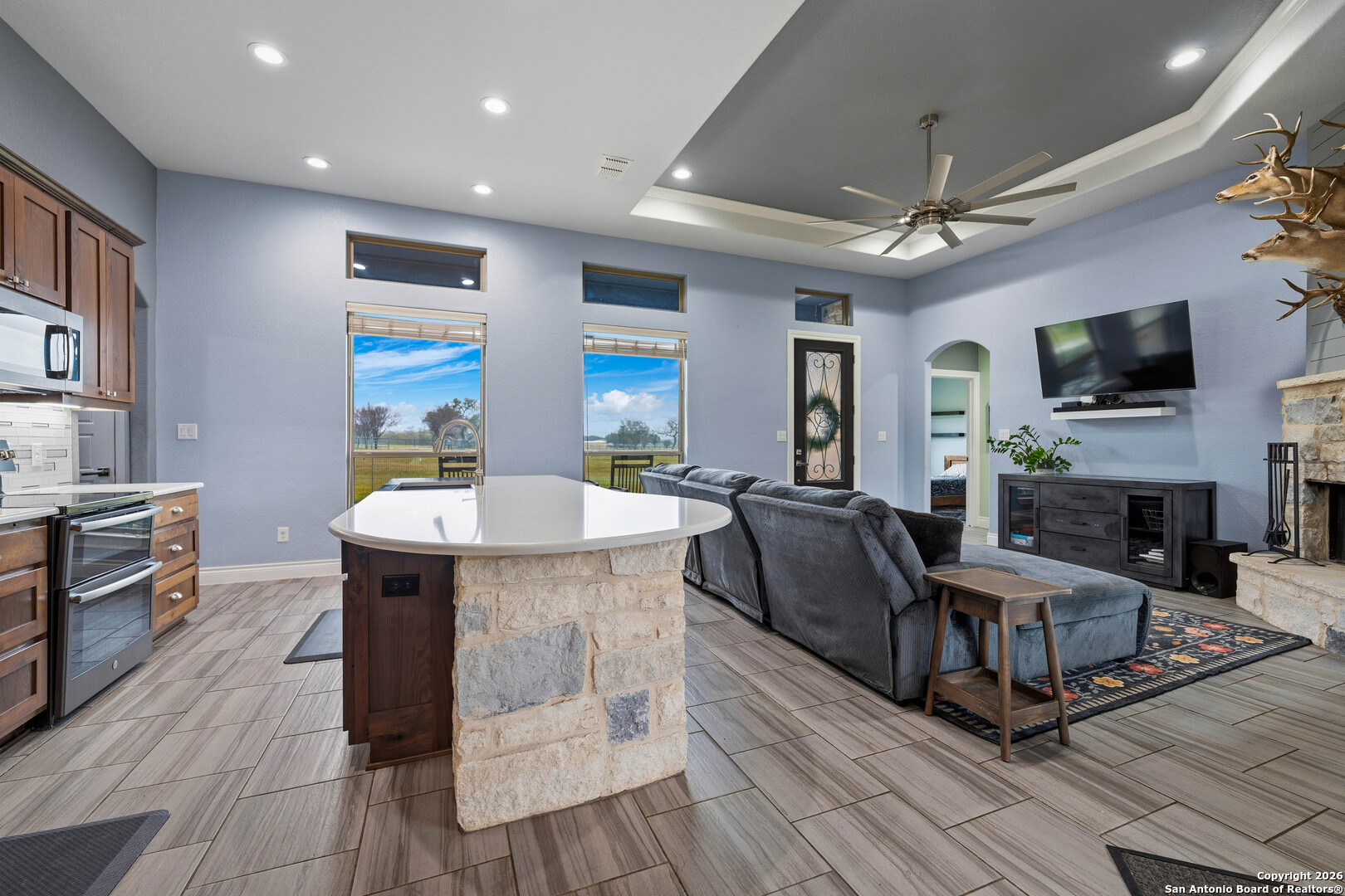 3585 Pittman Road St. Hedwig, TX 78152 - Photo 28 of 36 a living room with fireplace furniture and a flat screen tv