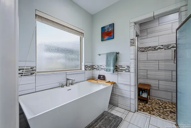 a bathroom with a bathtub and shower