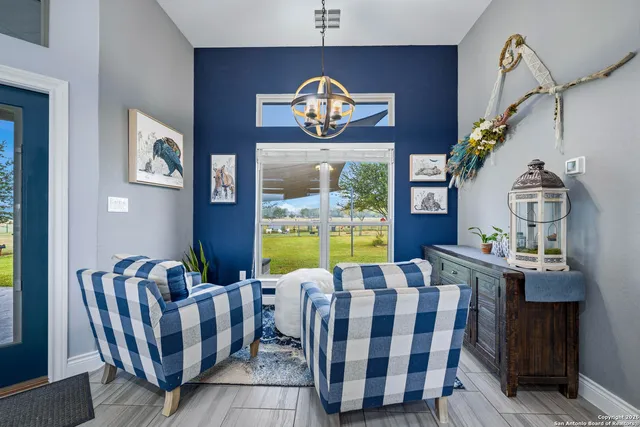 a view of a dining room with furniture one side kitchen view