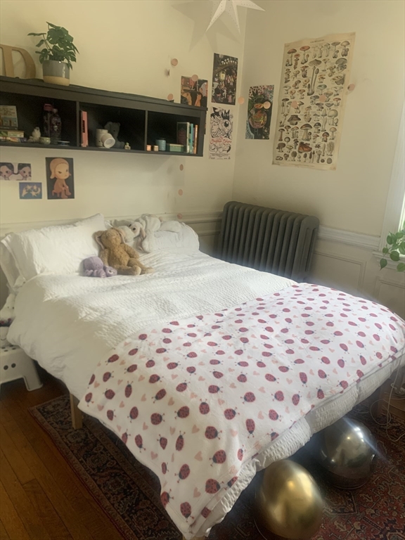 322 St Paul Street, Unit 1 Brookline, MA 02446 - Photo 3 of 9 a bedroom with a bed and a night stand