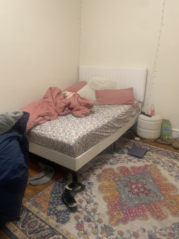 322 St Paul Street, Unit 1 Brookline, MA 02446 - Photo 5 of 9 a bedroom with a bed and wooden floor