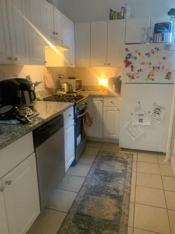 a kitchen with a stove a sink and a refrigerator