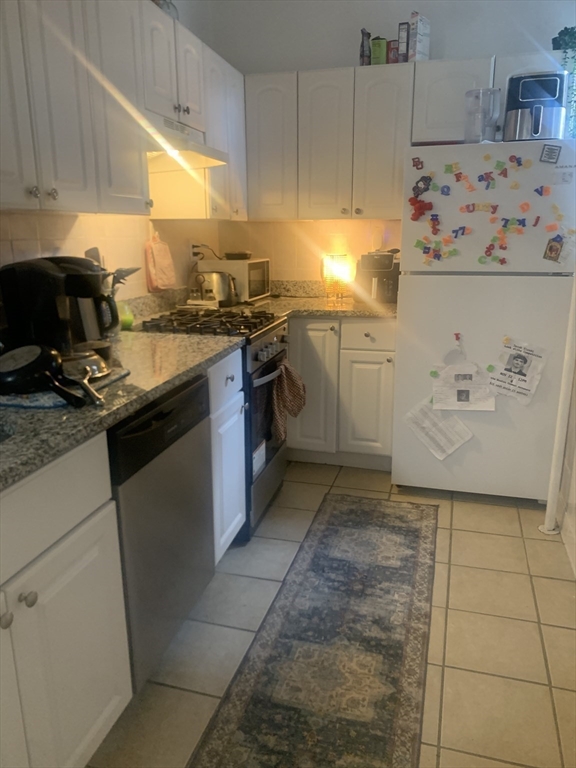 322 St Paul Street, Unit 1 Brookline, MA 02446 - Photo 7 of 9 a kitchen with a stove a sink and a refrigerator