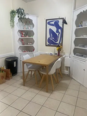 a dining room with furniture and wooden floor