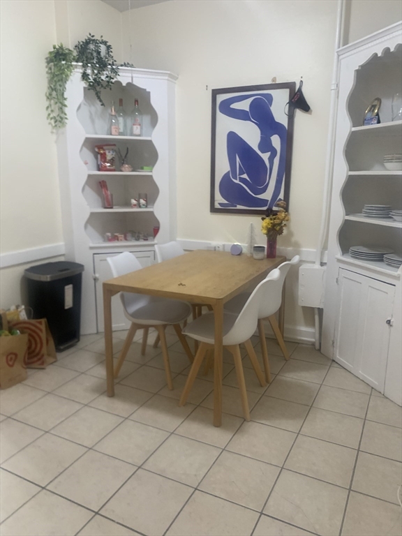 322 St Paul Street, Unit 1 Brookline, MA 02446 - Photo 8 of 9 a dining room with furniture and wooden floor