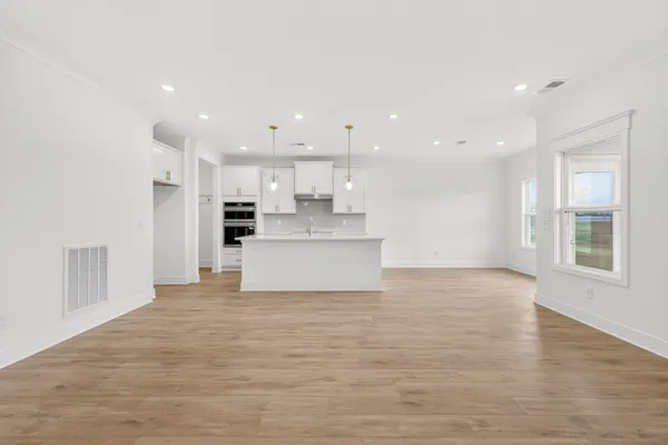 a view of a kitchen with a sink and wooden floor
