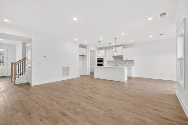 a view of an empty room with wooden floor
