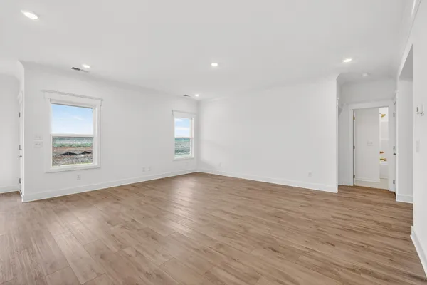 an open kitchen with white cabinets and sink