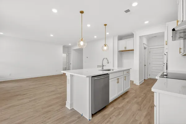 a kitchen with a sink a stove and cabinets
