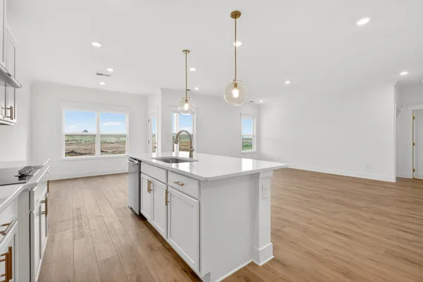 a kitchen with two sink and cabinets