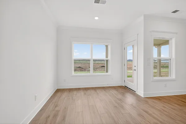 a view of an entryway with wooden floor