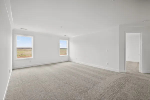 a view of a room with a window and a bed