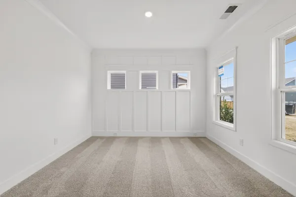 an empty room with windows and closet