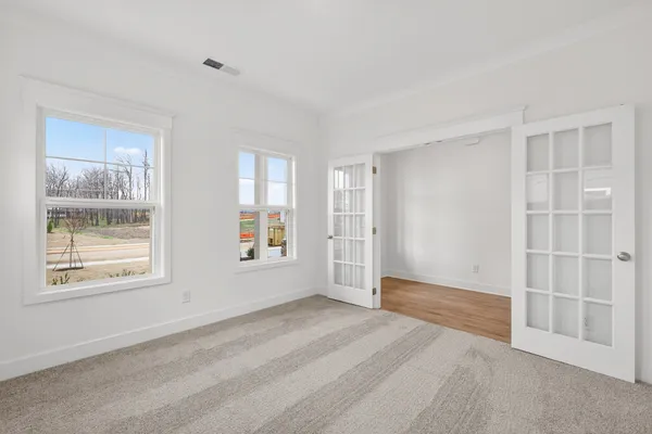 a view of entryway and hall with wooden floor
