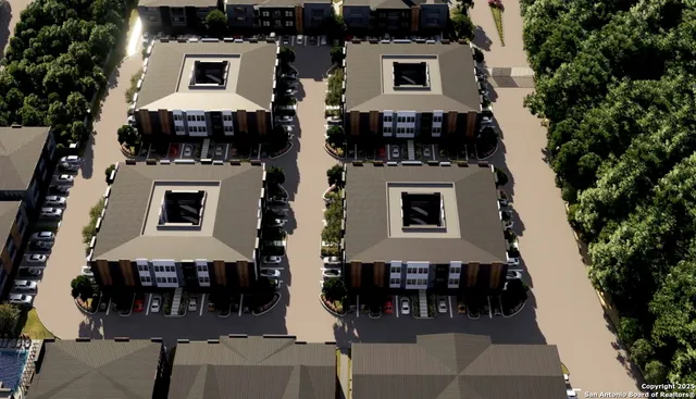 an aerial view of a house with a yard and large tree