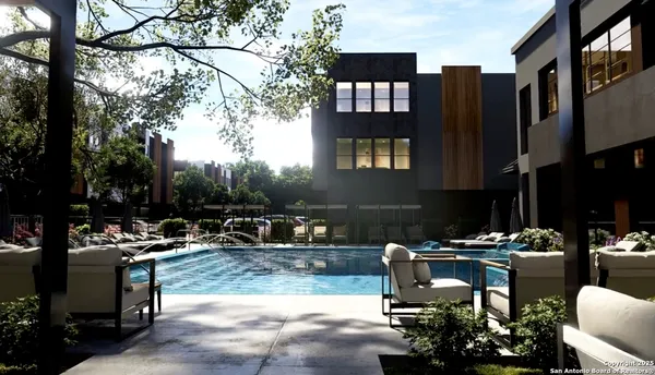 a swimming pool view with a outdoor seating