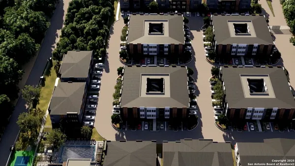 an aerial view of a house with a yard
