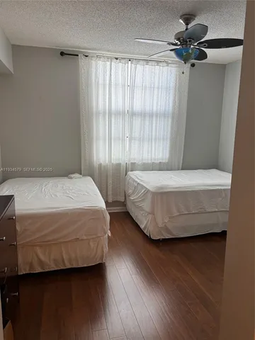 a bedroom with a bed a window and walk in closet