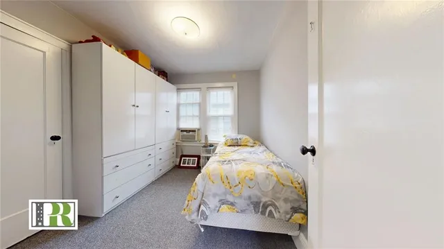 a bedroom with furniture and a window