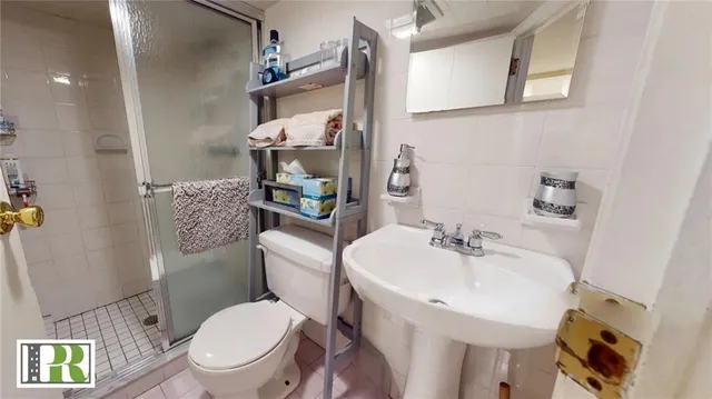 a white toilet sitting next to a bathroom sink