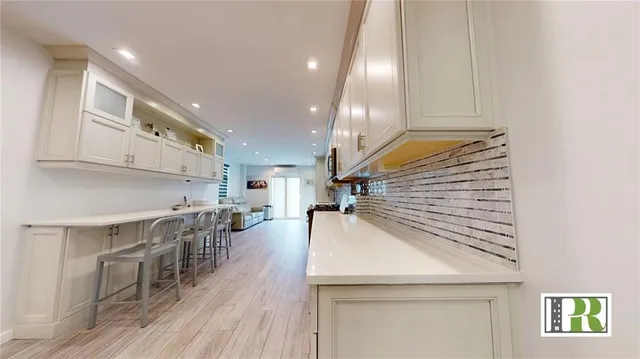 a kitchen with furniture and wooden floors
