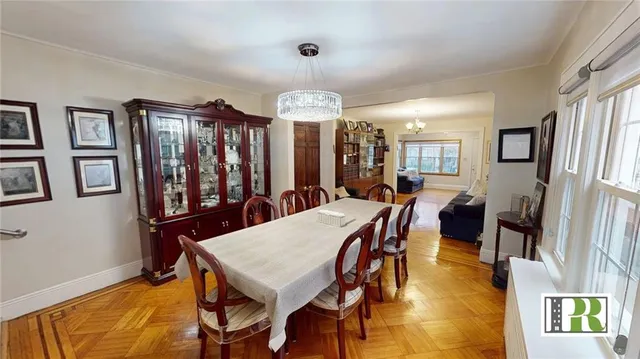 a view of a a dining room with furniture window and wooden floor