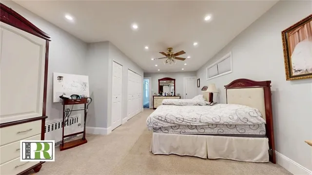 a spacious bedroom with a bed and a chandelier