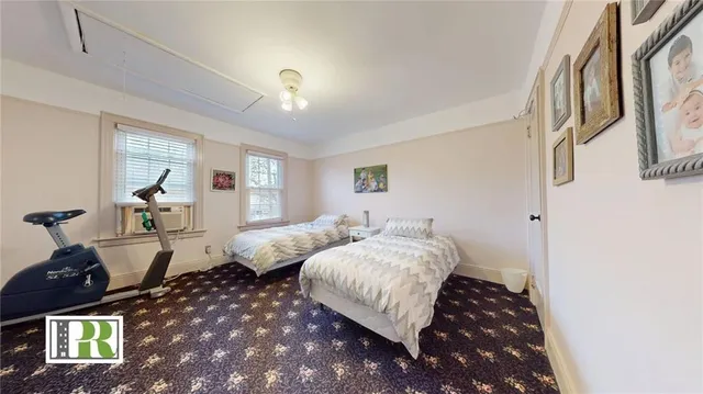 a bedroom with double bed and a window