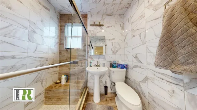 a white toilet sitting next to a bathroom sink