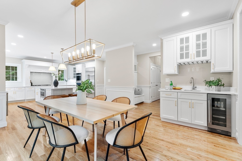 345 Grove Street Reading, MA 01867 - Photo 11 of 42 a kitchen with granite countertop white cabinets and stainless steel appliances