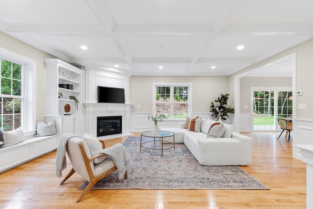 345 Grove Street Reading, MA 01867 - Photo 14 of 42 a living room with furniture a fireplace and a large window